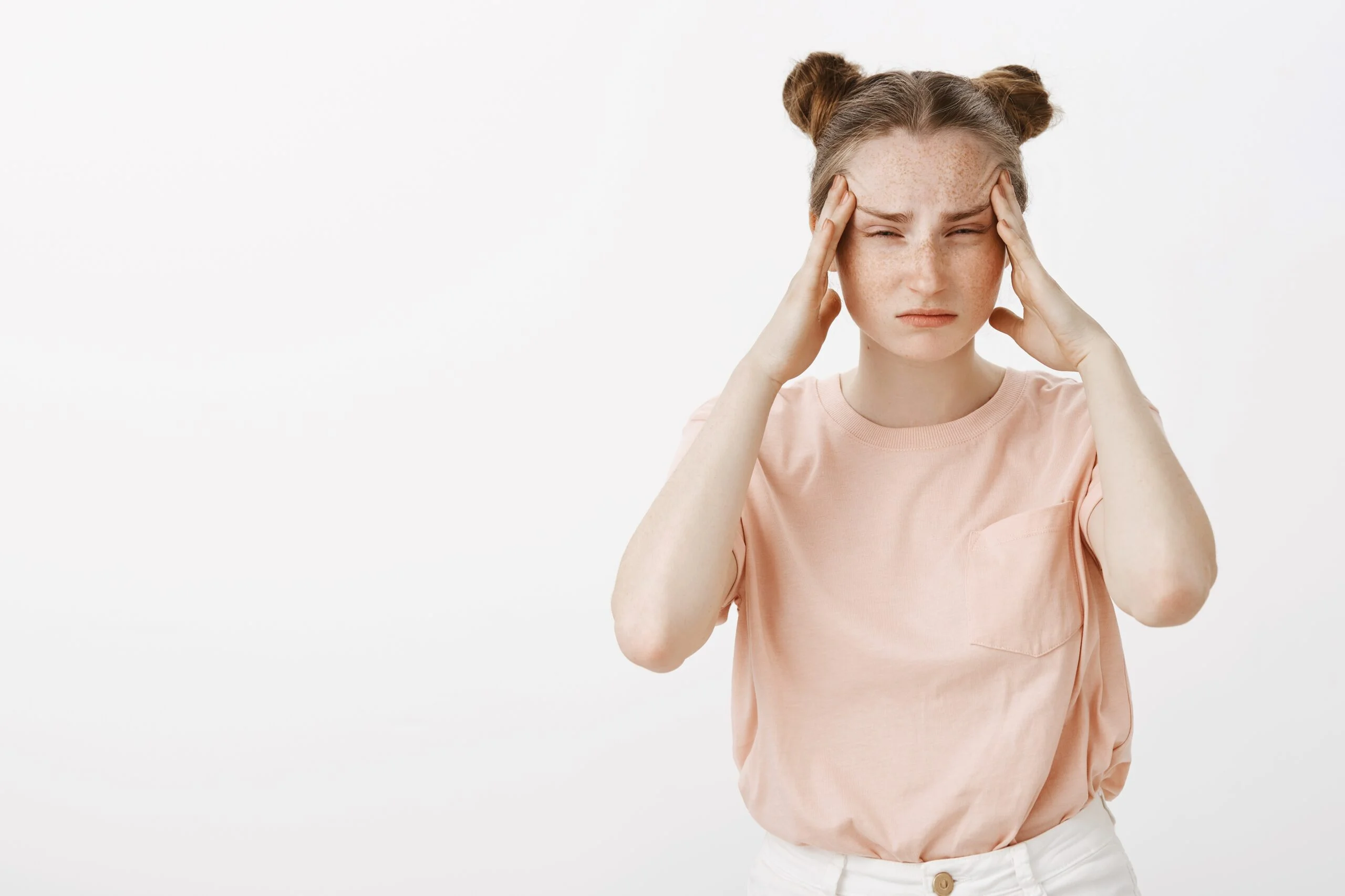 Anxious person pressing hands to temples