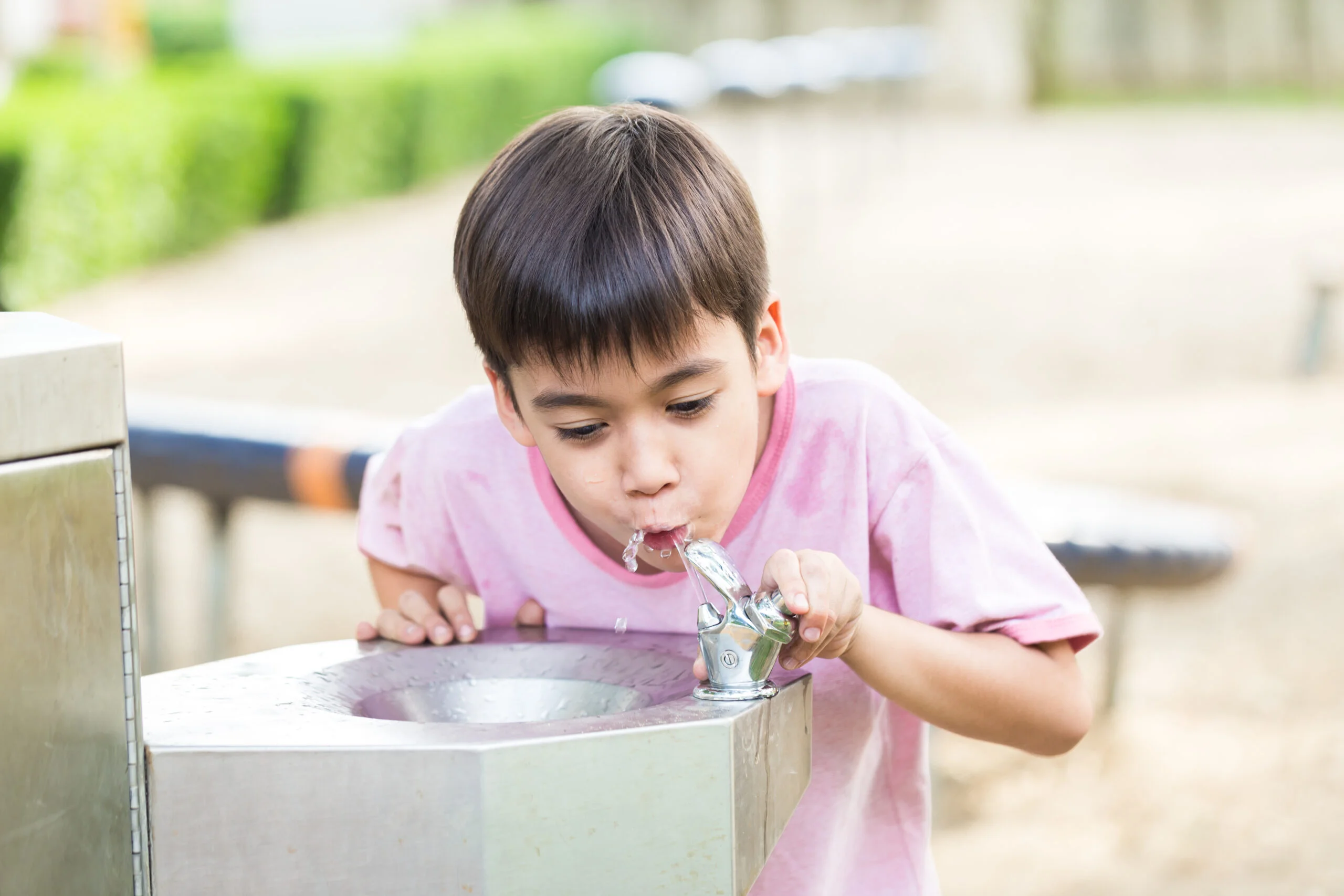 Boy at water fountain