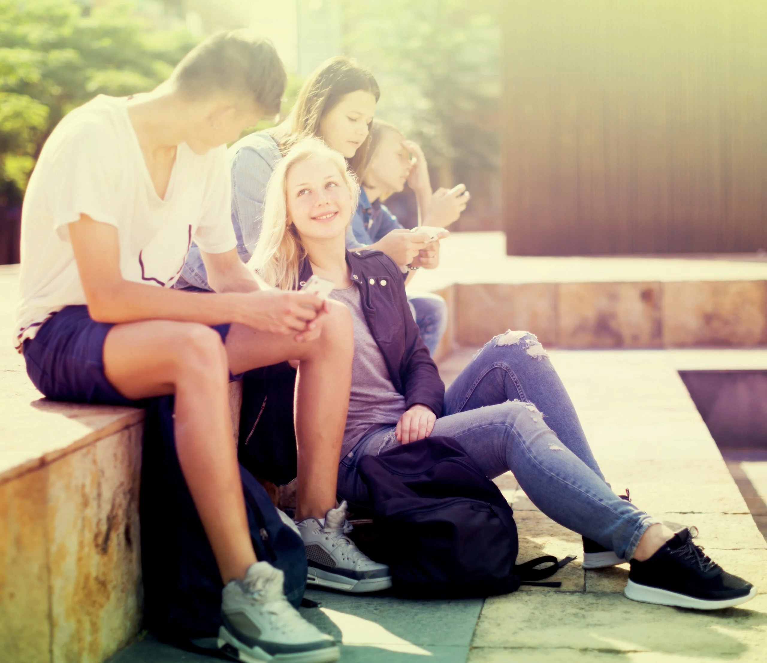 Teenage friends outside in sunshine
